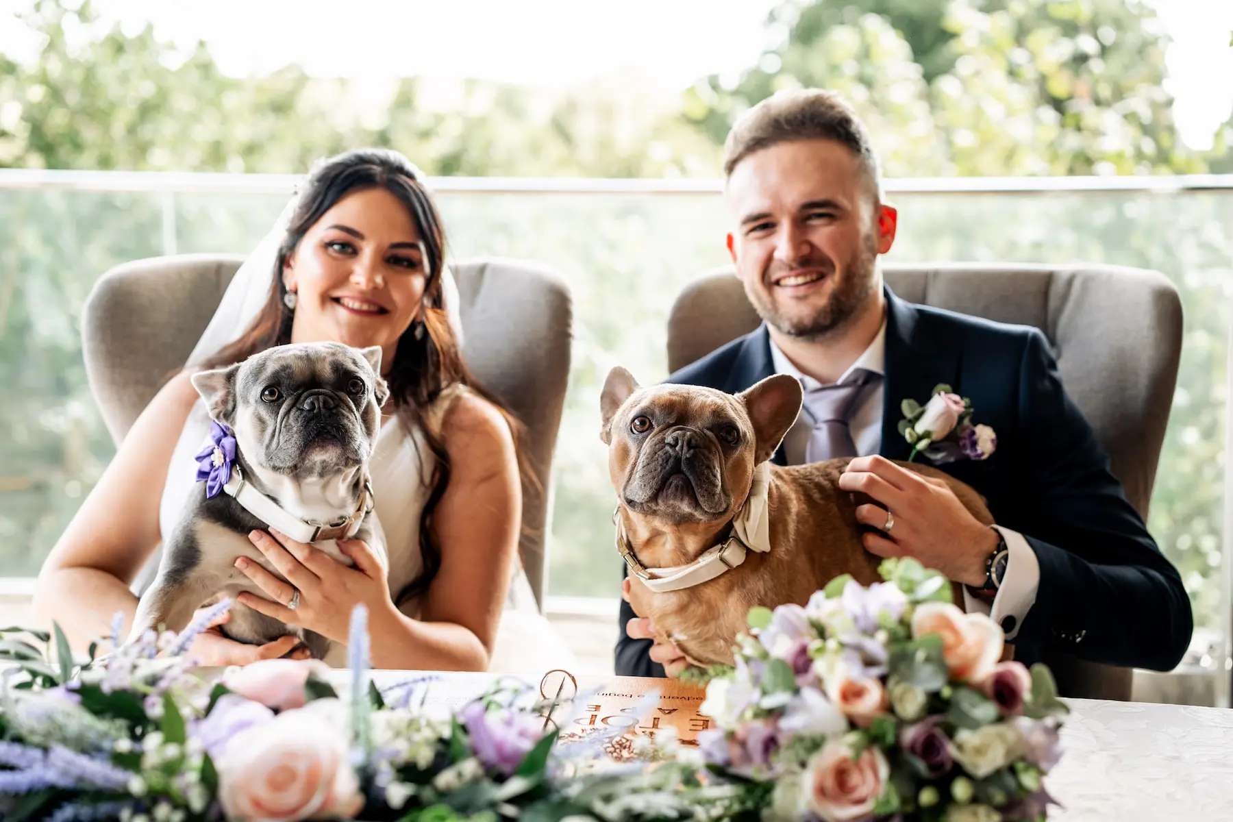 A happy couple with their two French Bulldogs on their wedding day at Tree Top Escape, North Devon
