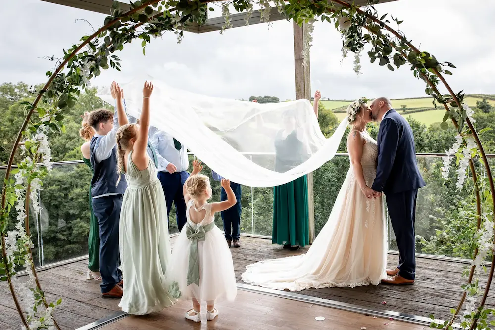 Children taking part in a wedding ceremony at Tree Top Escape intimate wedding venue, North Devon