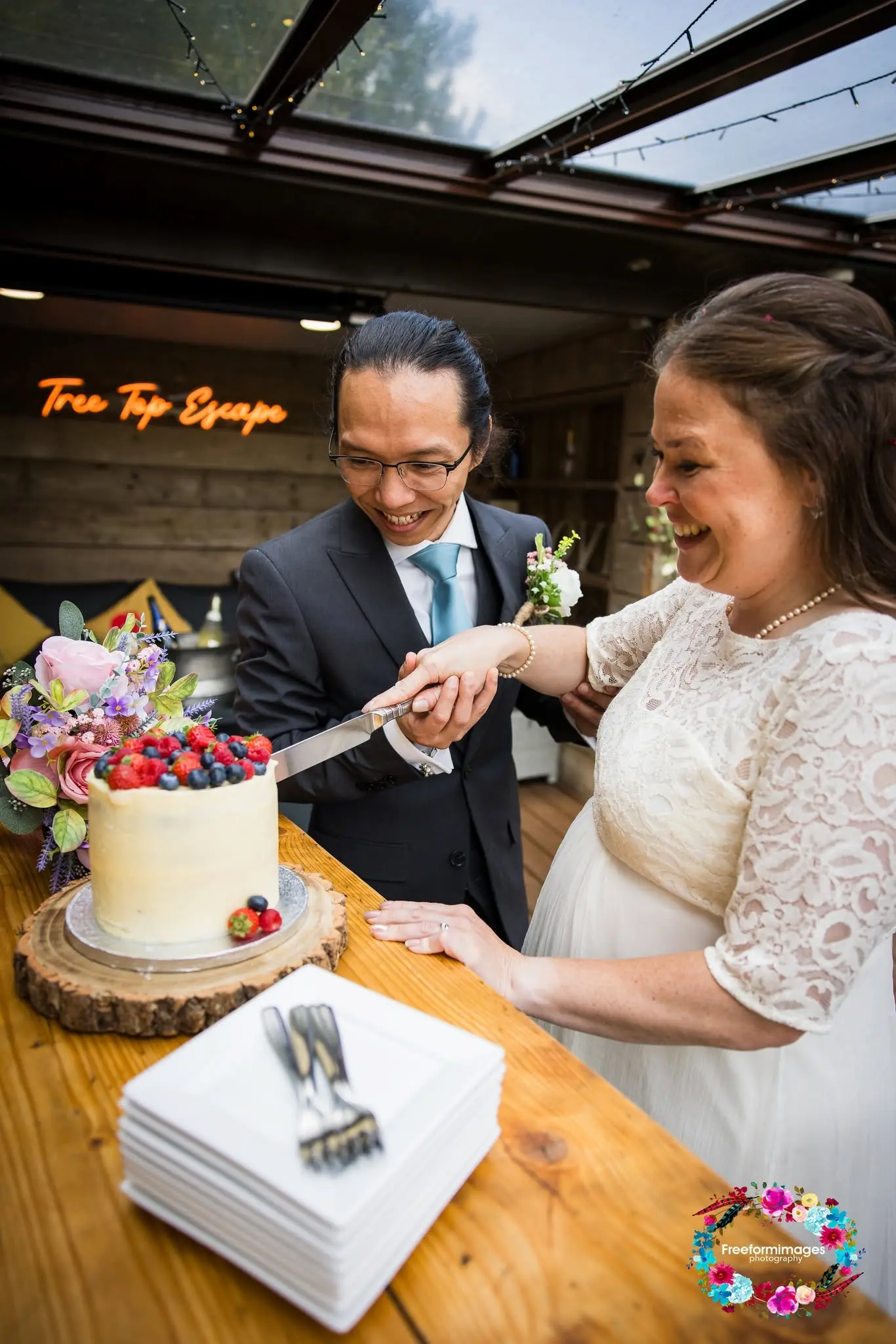 Single-tier semi-naked wedding cake topped with white and pink roses by Old Parlour Bakes