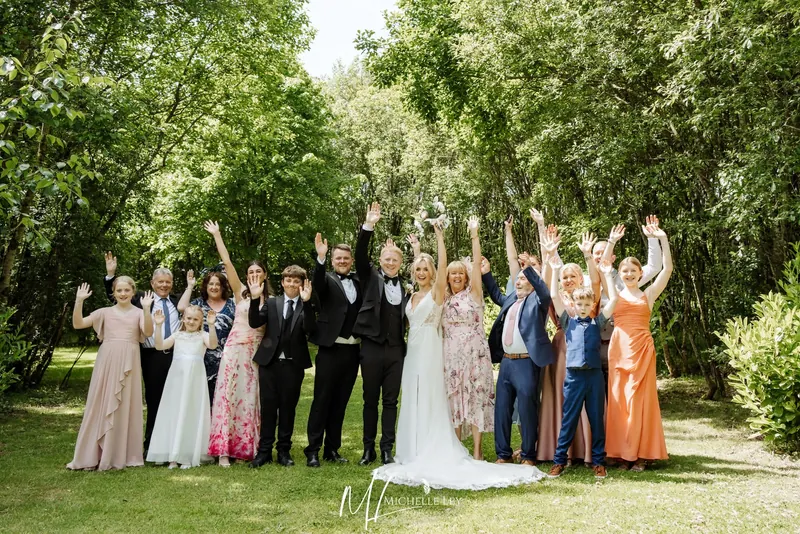 Wedding couple and family waving in the woodland at Tree Top Escape